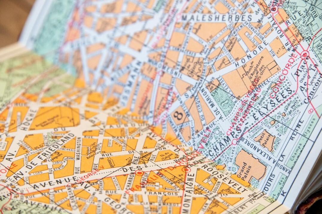 Notebook with a street map and charts on a table