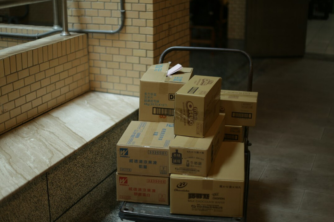 Delivery boxes stacked next to a van